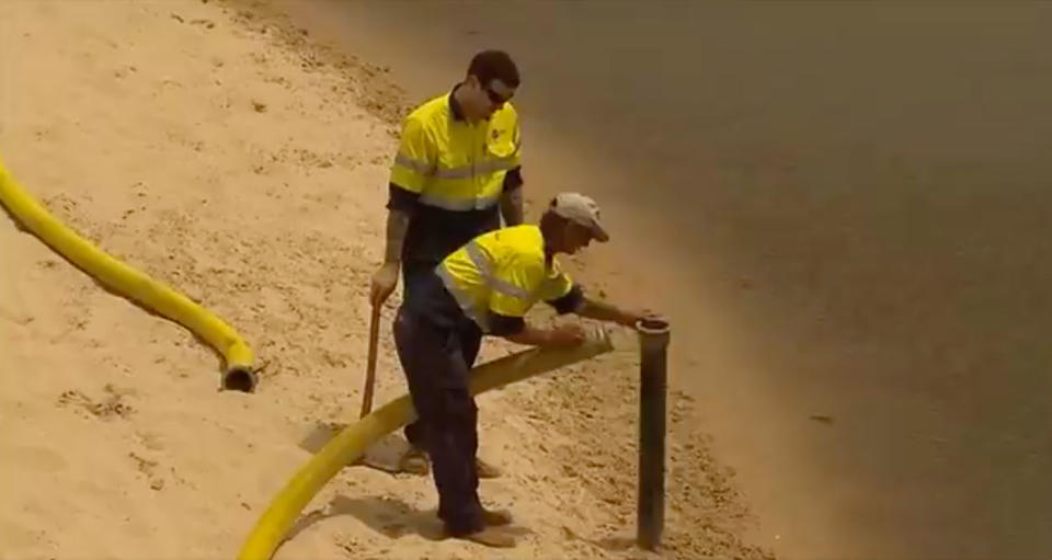 SA Water says the incident was caused by a break-in at the Christies Beach Wastewater Treatment Plant. Workers are seen dealing with the sludge. Source: 7 News