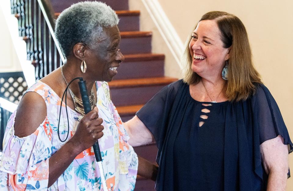 Jenny Savage, regional director of the Alabama Institute for Deaf and Blind, shares a laugh April 16 with Annie Reeves at the AIDB offices in Montgomery.