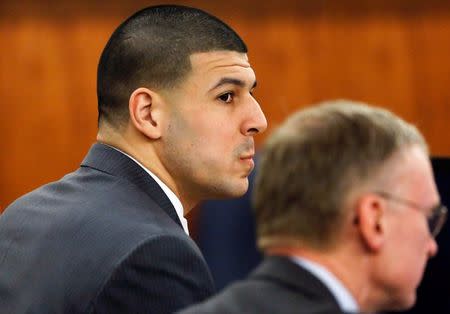 Former New England Patriots football player Aaron Hernandez (L), sits with his defense attorney Charles Rankin during his murder trial in Fall River, Massachusetts March 26, 2015. REUTERS/Steven Senne/Pool