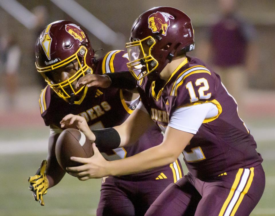 East Peoria quarterback Dalton Oakman hands the ball off the running back R.J. Jackson in the first half of their Week 3 football game Friday, Sept. 13, 2024 at EastSide Centre in East Peoria. The Raiders defeated the Limestone Rockets 47-28.