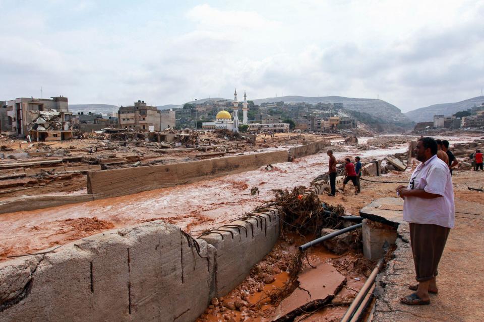 People look at the damage caused by freak floods in Derna, eastern Libya, on September 11, 2023. / Credit: AFP via Getty Images