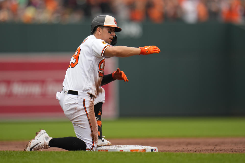 Baltimore Orioles' Ramon Urias reacts after collecting a triple against the Houston Astros in the third inning of a baseball game, Thursday, Aug. 10, 2023, in Baltimore. (AP Photo/Julio Cortez)