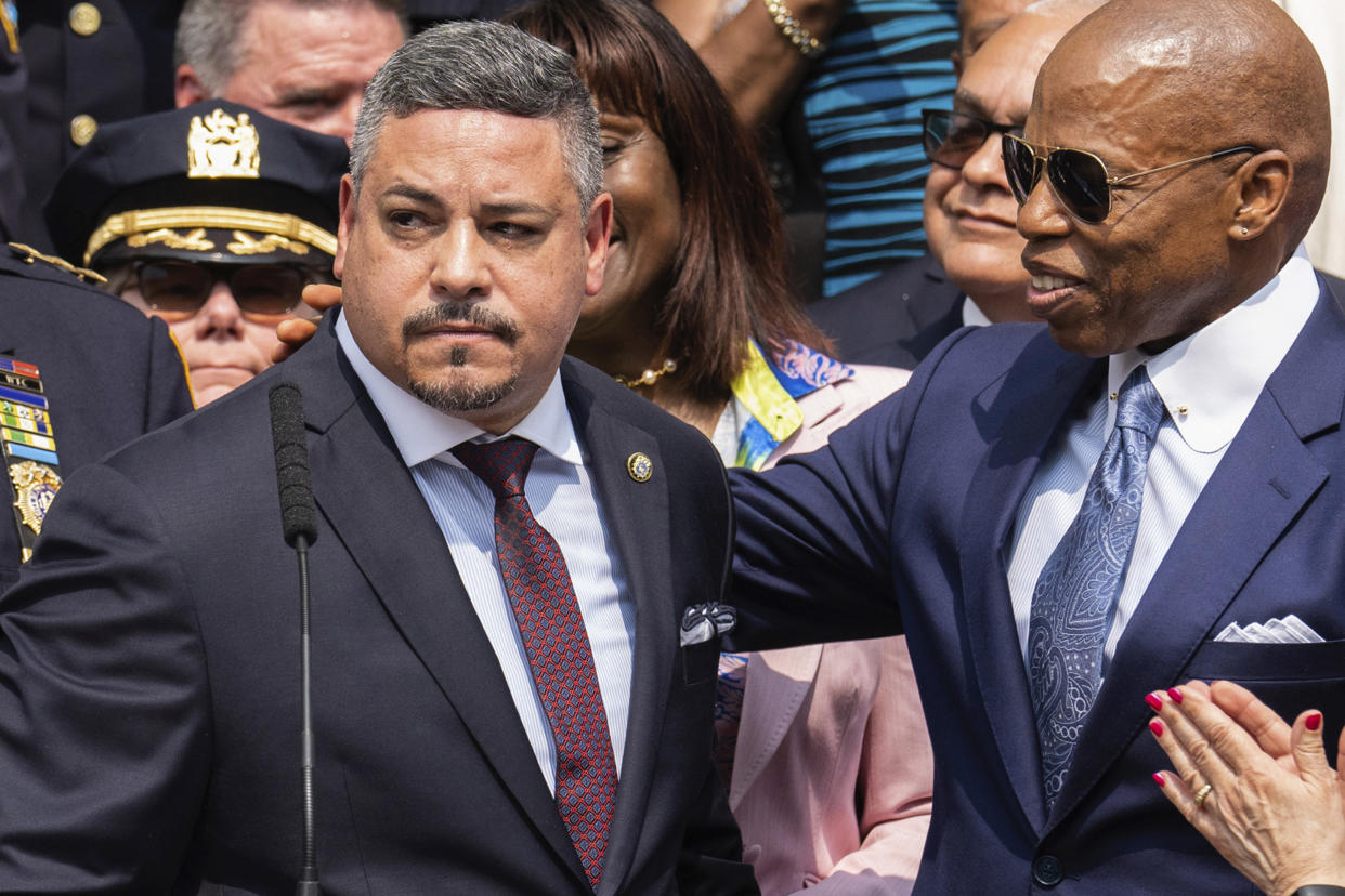 Edward A. Caban and New York City Mayor Eric Adams stand among others.