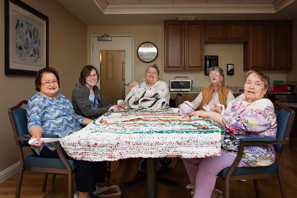 From left to right, Karen Damerville, Sharon Esche, Cathy Kownacki, Joanie Miller and Joyce Miller show off the mats they created out of plastic bags at Grand Living in West Des Moines.