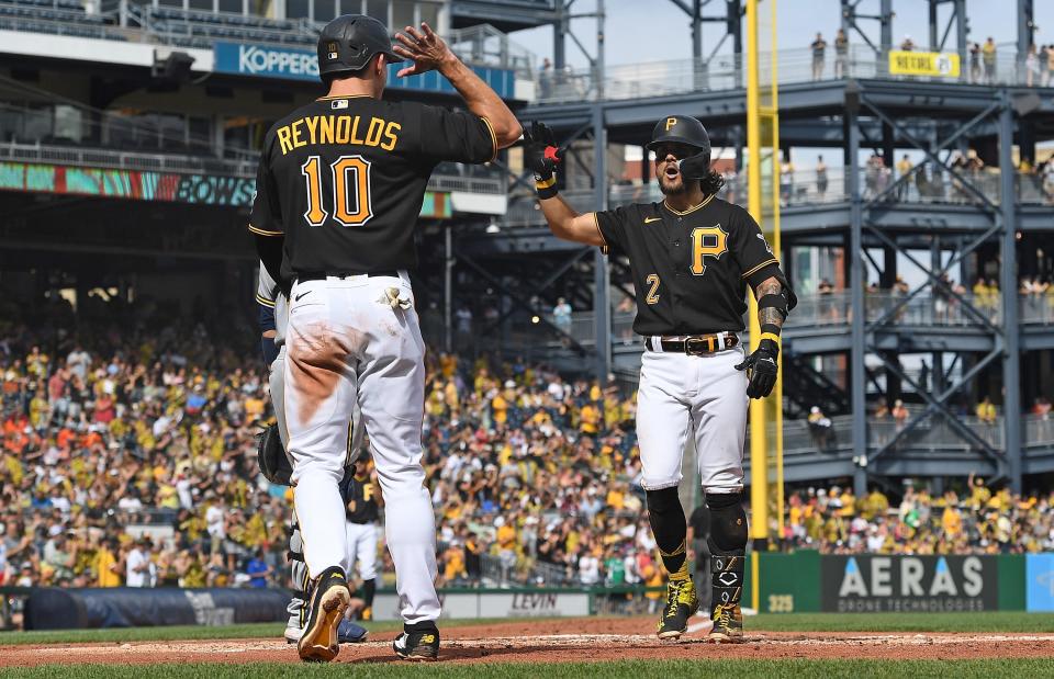 Michael Chavis of the Pirates celebrates with Bryan Reynolds as Chavis crosses home plate after hitting a two-run homer in the third inning against the Brewers on Saturday.