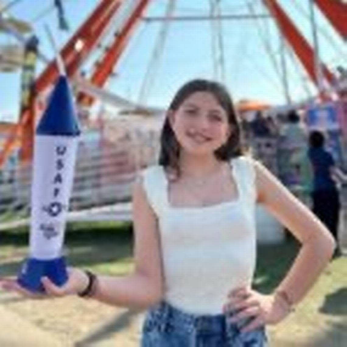 A girl holding a Rocket Iced Tea cup.