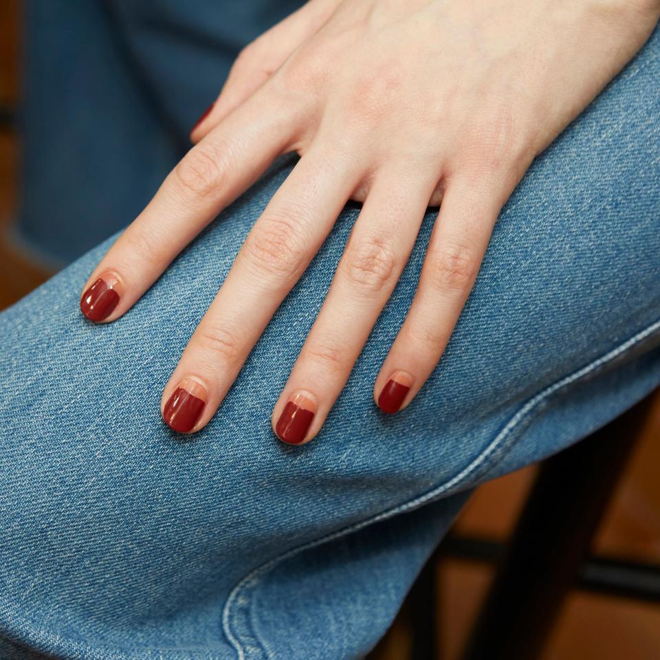 This twist on the classic crescent moon manicure showed up on the <a href="https://www.allure.com/gallery/best-nyfw-fall-2020-nail-art-manicures?mbid=synd_yahoo_rss" rel="nofollow noopener" target="_blank" data-ylk="slk:Veronica Beard Fall 2020 runway;elm:context_link;itc:0;sec:content-canvas" class="link ">Veronica Beard Fall 2020 runway</a>, courtesy of nail artist Rita Remark. Rather than paint a curve near the cuticle, she painted a horizontal line of Essie's <a href="https://shop-links.co/1698156531996275306" rel="nofollow noopener" target="_blank" data-ylk="slk:Cliff Hanger;elm:context_link;itc:0;sec:content-canvas" class="link ">Cliff Hanger</a> near the nail bed to kick off a color-blocked look which naturally created a feeling of color-blocking. Most of the nail is covered in the brick-hued Essie shade <a href="https://shop-links.co/1698156506867566972" rel="nofollow noopener" target="_blank" data-ylk="slk:Bed Rock & Roll;elm:context_link;itc:0;sec:content-canvas" class="link ">Bed Rock & Roll</a>, which is about as autumnal as a nail color can get.