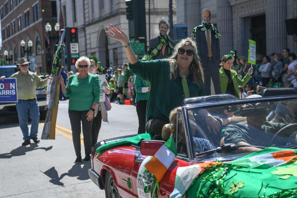Democratic State Rep. Gloria Johnson waves at parade goers as her vehicle progresses down Gay Street during Knoxville's annual St. Patrick's Day Parade on March 16.