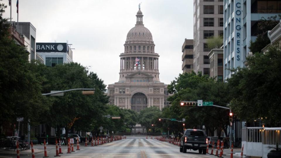 Cars drive on Congress Avenue in front of the Texas Capitol building on July, 14, 2020 in Austin, Texas. (Photo by Montinique Monroe/Getty Images)
