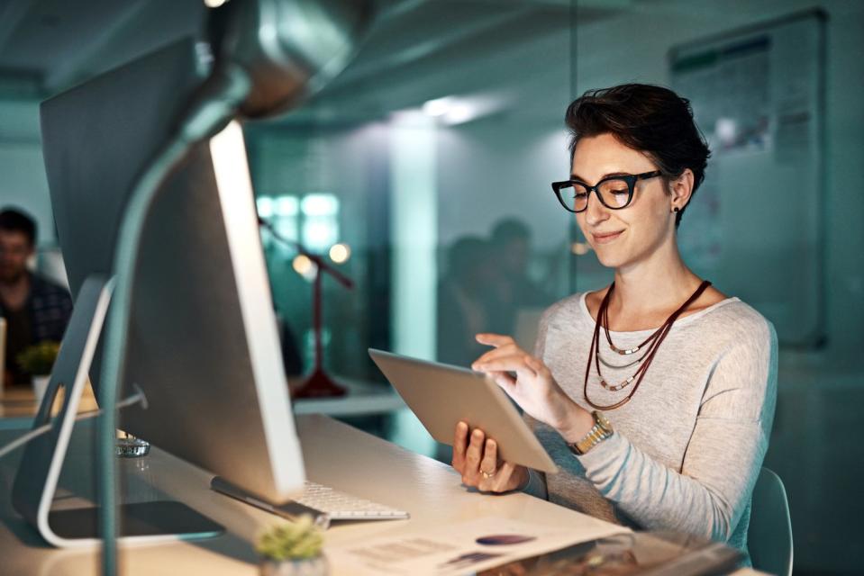 An investor in an office looks at something on a tablet.