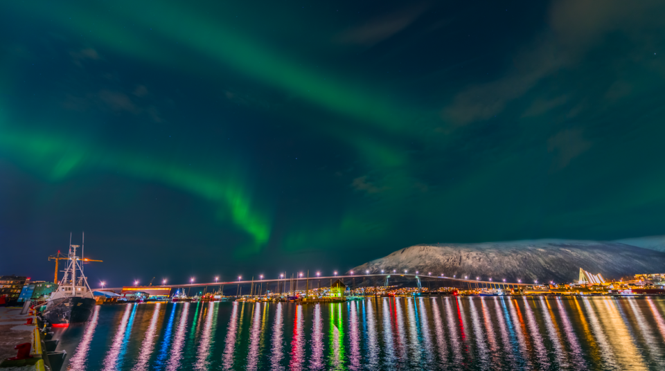 <p>The photographer captured nature’s answer to a stunning firework display as the Northern Lights dance above a rainbow cast in the waters of the harbour in Trømso, Norway. (Pic: Derek Burdeny) </p>