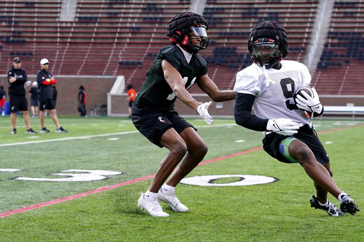 Cincinnati Bearcats wide receiver Aaron Turner turns downfield after completing a catch as defensive back Jayden Davis defends during spring football practice in early March. Davis has since transferred to Georgia Tech.