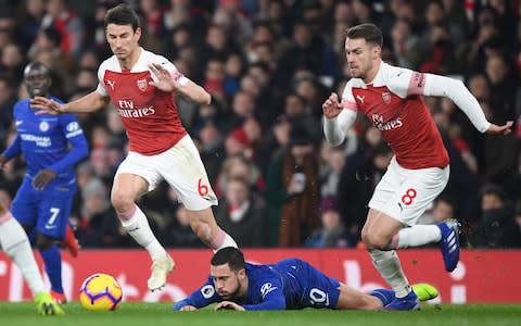 Laurent Koscielny and (R) Aaron Ramsey take on (2ndL) Eden Hazard of Chelsea of Arsenal during the Premier League match between Arsenal FC and Chelsea FC at Emirates Stadium - Credit: Getty Images