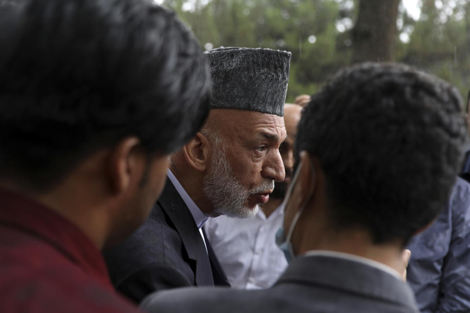 Afghanistan's former President Hamid Karzai talks with journalists after a news conference in Kabul, Afghanistan, Tuesday, July 13, 2021. Former President Karzai calls on both the Afghan government and the Taliban to resume negotiations and end fighting in the country. (AP Photo/Rahmat Gul)