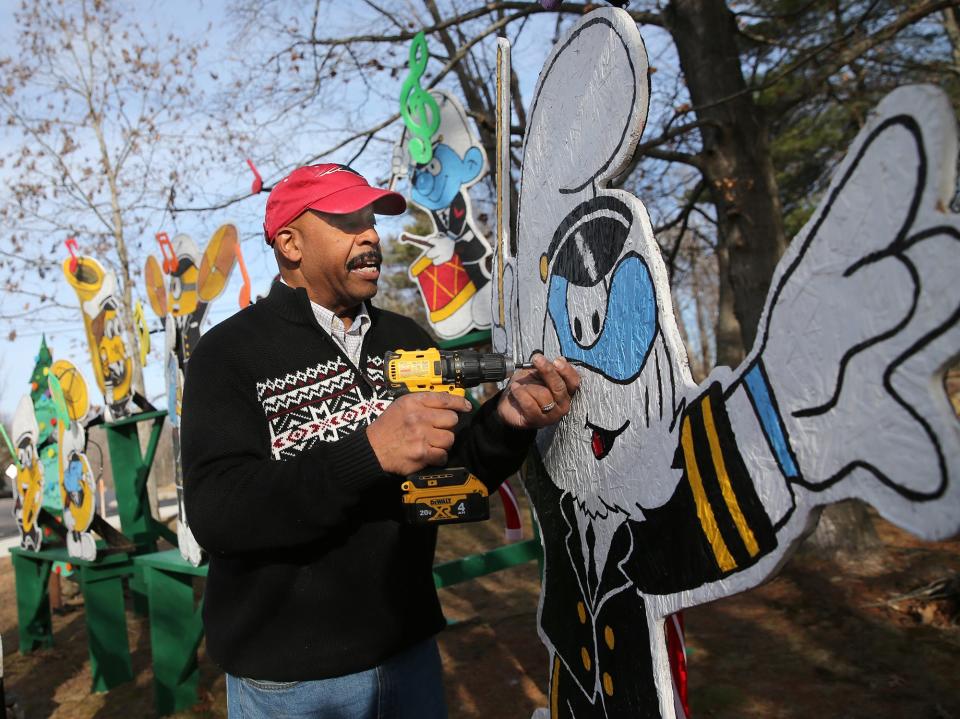 Al Bailey has been creating a different themed holiday display for 36 years. After a strong wind Thursday, Dec. 15, 2022, he reinforces Papa Smurf as the conductor of what he calls the Portsmouth Naval Shipyard band.