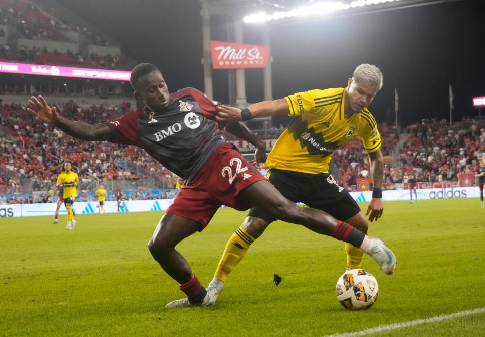 Sep 18, 2024; Toronto, Ontario, CAN; Columbus Crew forward Cucho Hernandez (9) and Toronto FC midfielder Richie Laryea (22) battle for the ball at BMO Field. Mandatory Credit: John E. Sokolowski-Imagn Images