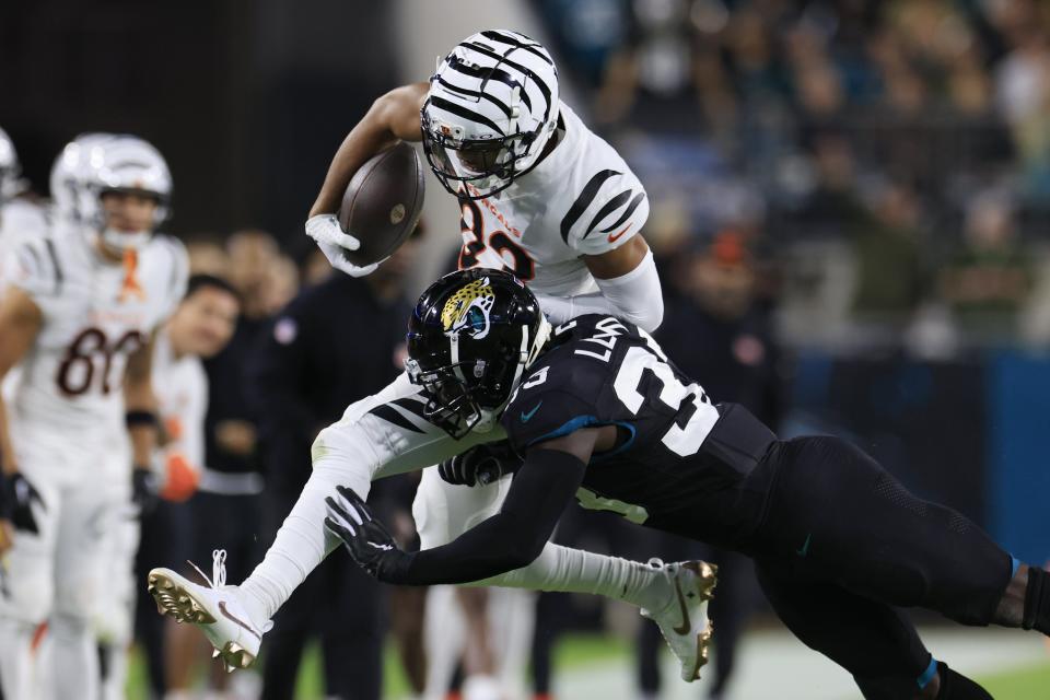 Jacksonville Jaguars linebacker Devin Lloyd (33) tackles Cincinnati Bengals wide receiver Tyler Boyd (83) out of bounds during the second quarter of a regular season NFL football matchup Monday, Dec. 4, 2023 at EverBank Stadium in Jacksonville, Fla. [Corey Perrine/Florida Times-Union]