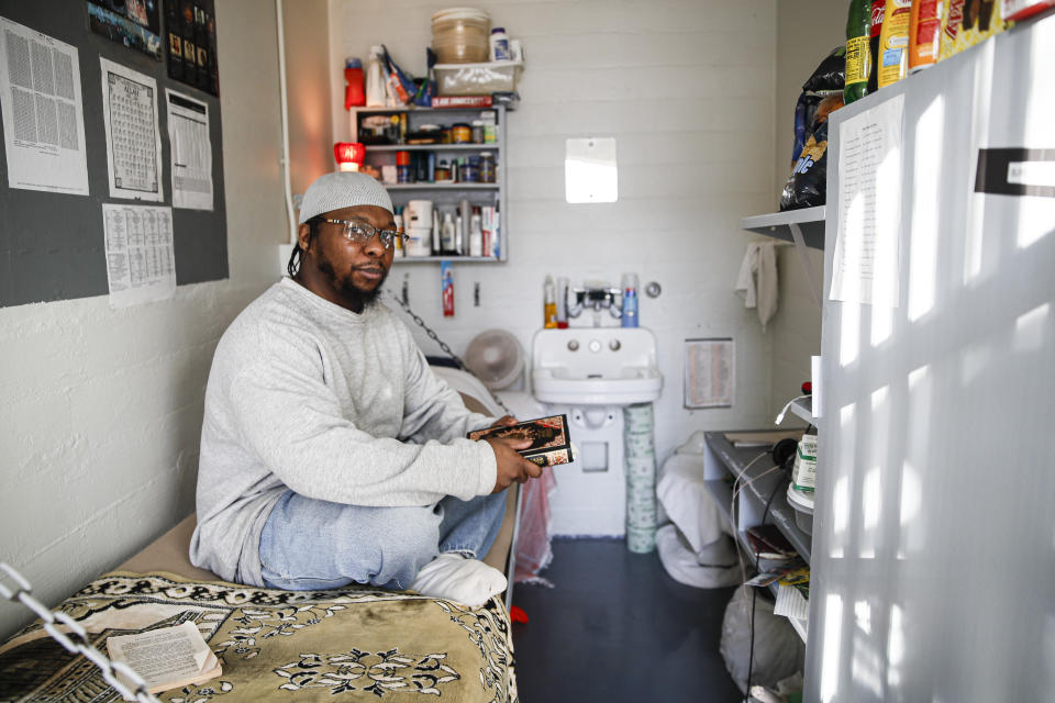 FILE - In this Feb. 13, 2020 file photo, Myon Burrell sits inside his cell at the Minnesota Correctional Facility in Stillwater. Burrell was 16 in 2002 when he was accused of firing a gun that killed 11-year-old Tyesha Edwards as she sat at her dining room table doing homework. Surveillance tapes were never reviewed to check Burrell’s story, and friends with him that day were not interviewed. No DNA, fingerprints, or weapon was found in the case. Most of the jailhouse snitches used to convict Burrell have since recanted, and police are shown on a video offering a man $500 for every name he provides -- even if it’s hearsay. Burrell was sentenced to life. (AP Photo/John Minchillo)