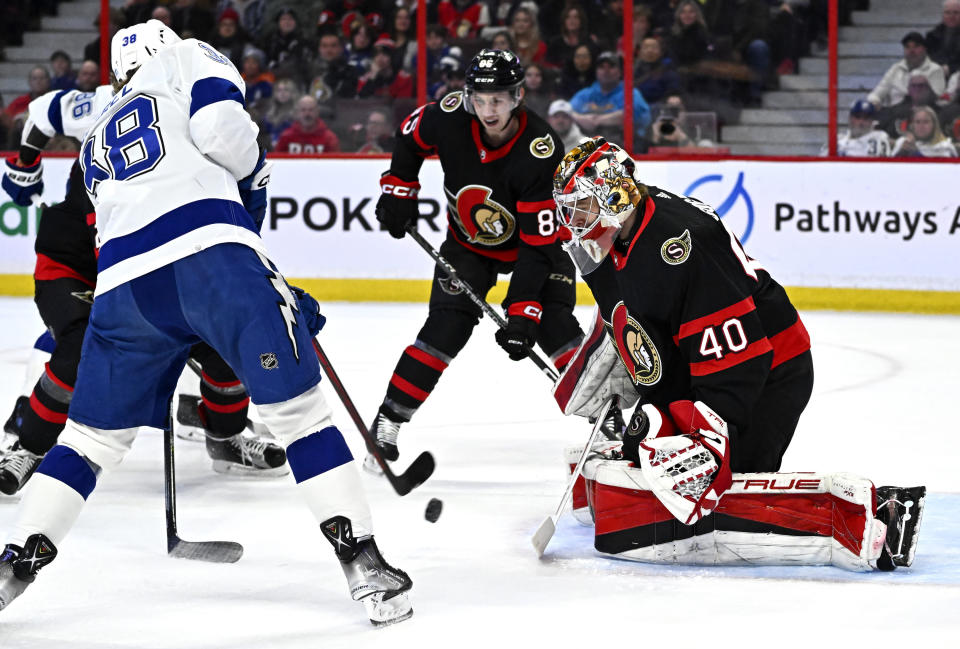 Ottawa Senators goaltender Mads Sogaard (40) watches the puck on a shot by Tampa Bay Lightning left wing Brandon Hagel (38) during first-period NHL hockey game action in Ottawa, Thursday, March 23, 2023. (Justin Tang/The Canadian Press via AP)