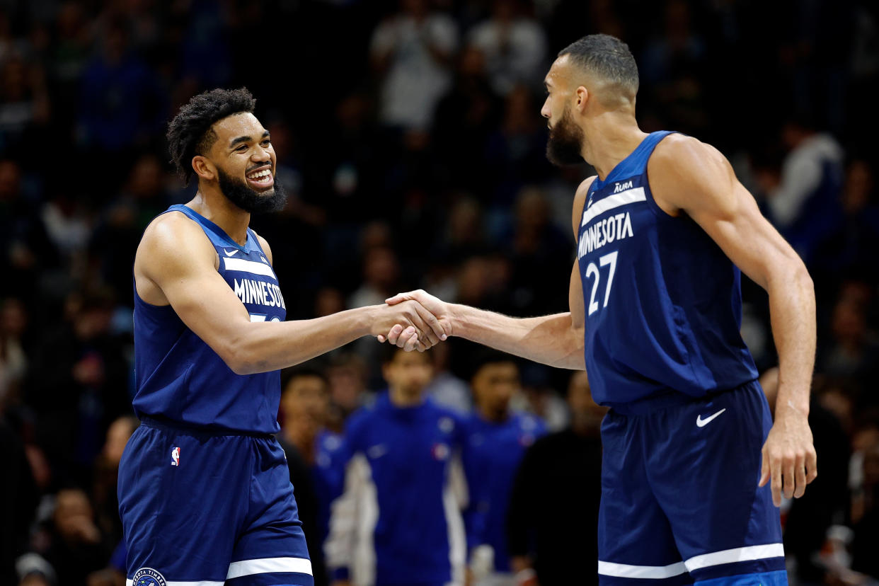 MINNEAPOLIS, MINNESOTA - NOVEMBER 22: Karl-Anthony Towns #32 and Rudy Gobert #27 of the Minnesota Timberwolves shake hands in the first quarter against the Philadelphia 76ers at Target Center on November 22, 2023 in Minneapolis, Minnesota. NOTE TO USER: User expressly acknowledges and agrees that, by downloading and or using this photograph, User is consenting to the terms and conditions of the Getty Images License Agreement. (Photo by David Berding/Getty Images)