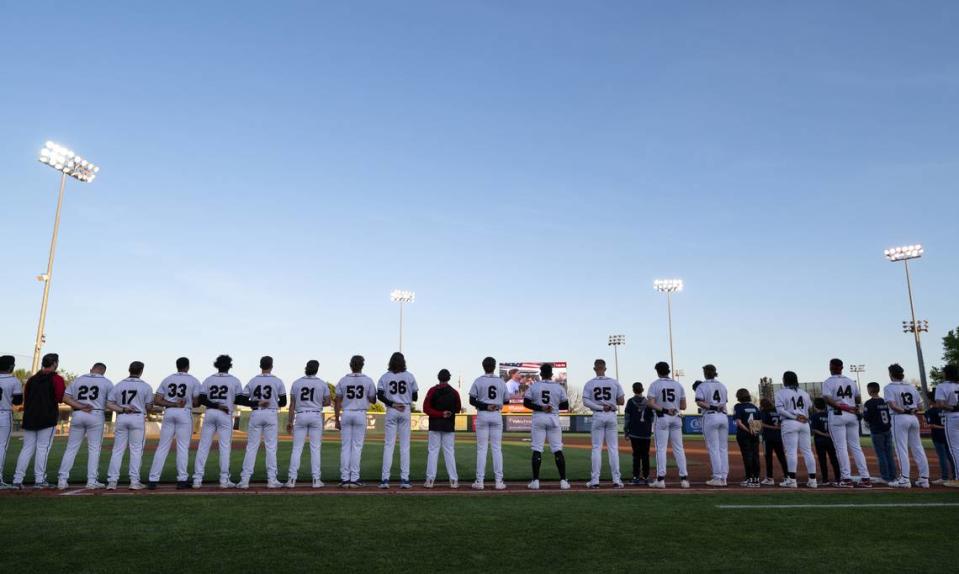 Modesto Nuts team stands for the National Anthem during season home opener with Lake Elsinore at John Thurman Field in Modesto, Calif., Tuesday, April 9, 2024. Andy Alfaro/aalfaro@modbee.com