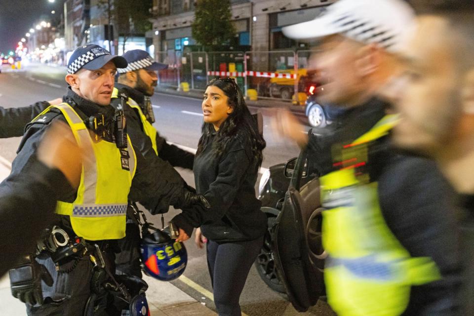 Two women are asked to leave the area after stoping to clash with protesters outside Kilburn Islamic Centre in London, they were protesting against the death of Iranian Mahsa Amini, a 22-year-old woman who died in Iran while in police custody, who was arrested by Iran’s morality police for allegedly violating its strictly-enforced dress code (PA)