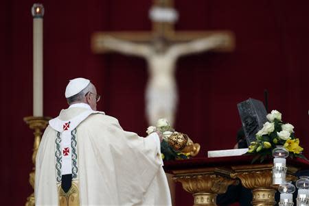 Pope Francis blesses the relics of the Apostle Peter on the altar during a mass at St. Peter's Square at the Vatican November 24, 2013. REUTERS/Stefano Rellandini