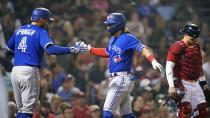 Toronto Blue Jays' Bo Bichette, center, is congratulated by George Springer (4) after his two-run home run off Boston Red Sox starting pitcher Nick Pivetta in the fifth inning of a baseball game at Fenway Park, Monday, July 26, 2021, in Boston. At right is Boston Red Sox catcher Christian Vazquez. (AP Photo/Charles Krupa)