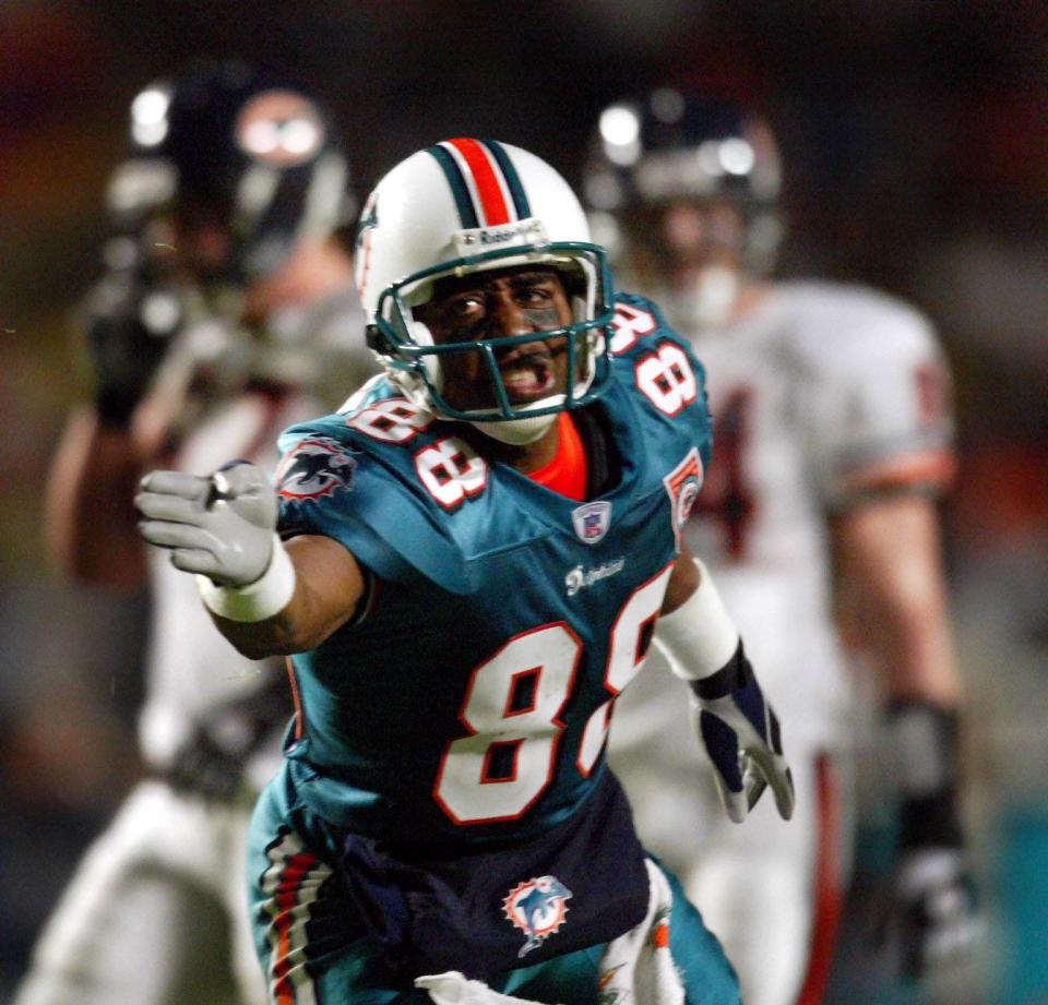 Cris Carter signals a first down after a reception for the Miami Dolphins in 2011.