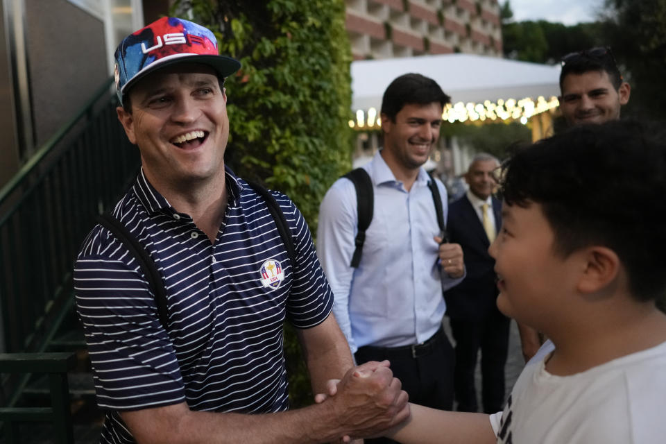 USA Ryder Cup team captain Zach Johnson shakes hands with a fan as he returns with members of his team at a hotel in Rome, Friday, Sept. 8, 2023, at the end of a practice session at the Marco Simone golf club. (AP Photo/Andrew Medichini)