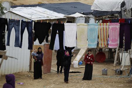 Women stand near a washing line in the Bedouin town of Rahat in southern Israel, in this December 10, 2013 file picture. REUTERS/Amir Cohen/Files