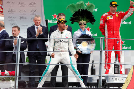 Formula One F1 - Italian Grand Prix - Circuit of Monza, Monza, Italy - September 2, 2018 Mercedes' Lewis Hamilton celebrates on the podium after winning the race alongside second placed Kimi Raikkonen of Ferrari REUTERS/Stefano Rellandini