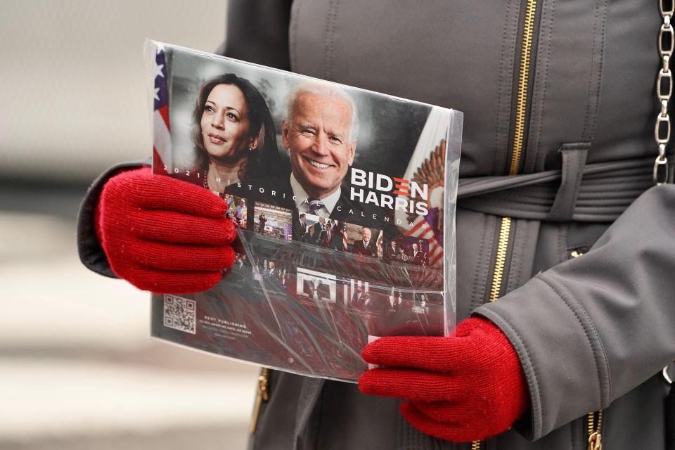 A customer holds a Biden-Harris calendar before buying it in Washington, DC, a few days before Inauguration Day. The nation's capital is on high-alert with heightened security against threats to President-elect Joe Biden’s inauguration  following the deadly pro-Trump insurrection at the U.S. Capitol.