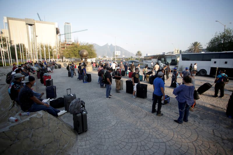 FILE PHOTO: Migrants seeking for a U.S. work visa after being evicted from hotel, which local authorities said was crowded, as part of measures to prevent the spreading of the coronavirus disease COVID-19, in Monterrey