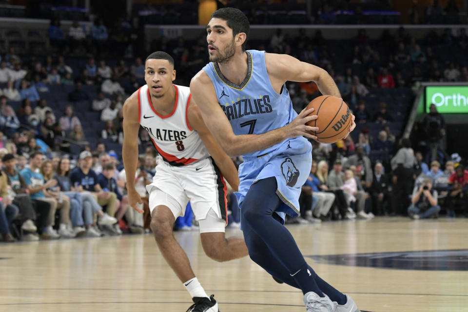 Memphis Grizzlies forward Santi Aldama (7) drives next toPortland Trail Blazers forward Kris Murray (8) during the first half of an NBA basketball game Saturday, March 2, 2024, in Memphis, Tenn. (AP Photo/Brandon Dill)