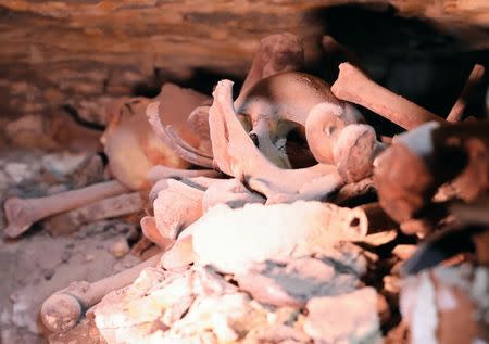 A skull and bones are seen inside a recently discovered burial shaft near Egypt's Saqqara necropolis, in Giza Egypt July 14, 2018. REUTERS/Mohamed Abd El Ghany