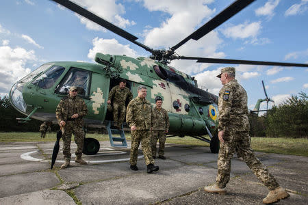 Ukrainian President Petro Poroshenko leaves a helicopter as he arrives for a test of the U.S. anti-tank missile systems at a shooting range in an unknown location, Ukraine May 22, 2018. Mikhail Palinchak/Ukrainian Presidential Press Service/Mikhail Palinchak/Handout via REUTERS