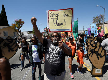 Protesters march from the intersection of Florence and Normandie Avenue, the flashpoint where the riots started 25 years ago, to a nearby park for a rally to remember and honor the victims of the 1992 Los Angeles riots in Los Angeles, California, U.S., April 29, 2017. REUTERS/Kevork Djansezian