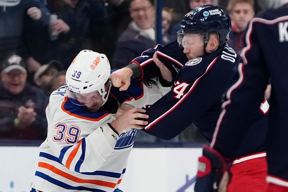 Mar 7, 2024; Columbus, Ohio, USA; Columbus Blue Jackets right wing Mathieu Olivier (24) fights Edmonton Oilers center Sam Carrick (39) during the first period of the NHL hockey game at Nationwide Arena.