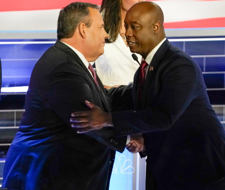 Former New Jersey Gov. Chris Christie. left, shakes hands with U.S. Sen. Tim Scott, R-S.C., at the conclusion of Wednesday night's Republican National Committee presidential primary debate.