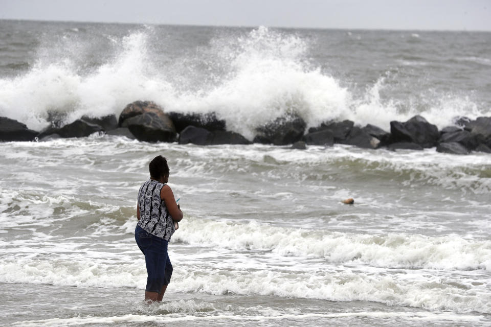 Gwen Patterson watches as waves crash ashore at Buckroe Beach in Hampton, Va., Thursday, Sept. 13, 2018 as Hurricane Florence approaches the coast. (Jonathon Gruenke/The Daily Press via AP)