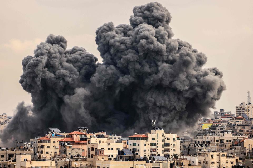 A plume of smoke rises in the sky of Gaza City during an Israeli airstrike on October 9, 2023.