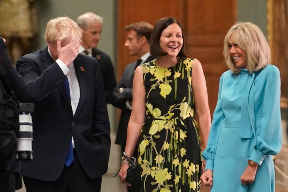Boris Johnson speaks with Annik Penders (centre), the wife of Belgian premier Alexander De Croo, and Brigitte Macron, wife of the French president in Madrid (AP)