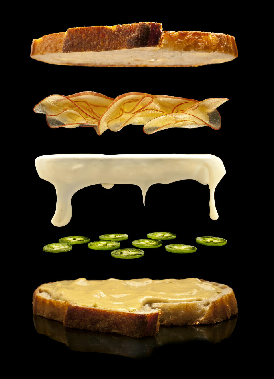 This undated illustration provided by Modernist Cuisine on July 16, 2013 shows aged white cheddar cheese on sourdough bread with apples, and sliced jalapenos. (AP Photo/Modernist Cuisine, Chris Hoover)