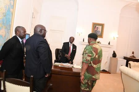 Zimbabwe's President Robert Mugabe meets with General Constantino Chiwenga as Roman Catholic Priest Father Fidelis Mukonori and Minister of Justice Brigadier General Happyton Bonyongwe look on, at State House in Harare, Zimbabwe November 19, 2017. ZIMPAPERS IMAGES/Joseph Nyadzayo/Handout via REUTERS ATTENTION EDITORS - THIS IMAGE HAS BEEN SUPPLIED BY A THIRD PARTY. NO RESALES. NO ARCHIVES. ZIMBABWE OUT.