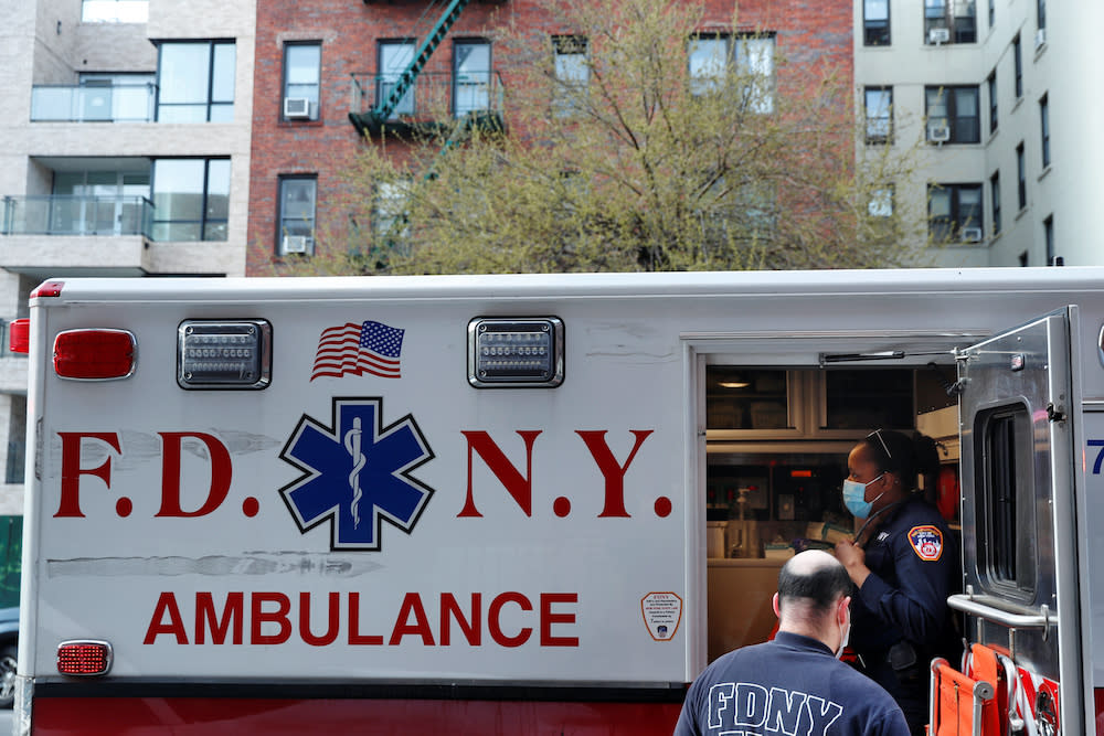 New York City Fire Department Emergency Medical Technicians assist a woman during ongoing outbreak of the coronavirus disease in New York, April 15, 2020. ― Reuters  pic