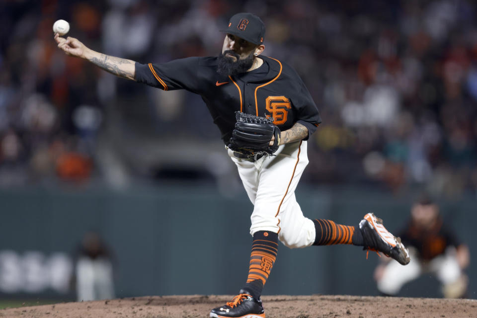 San Francisco Giants pitcher Sergio Romo (54) throws against the Oakland Athletics during the seventh inning of a spring training baseball game in San Francisco, Monday, March 27, 2023. (AP Photo/Jed Jacobsohn)