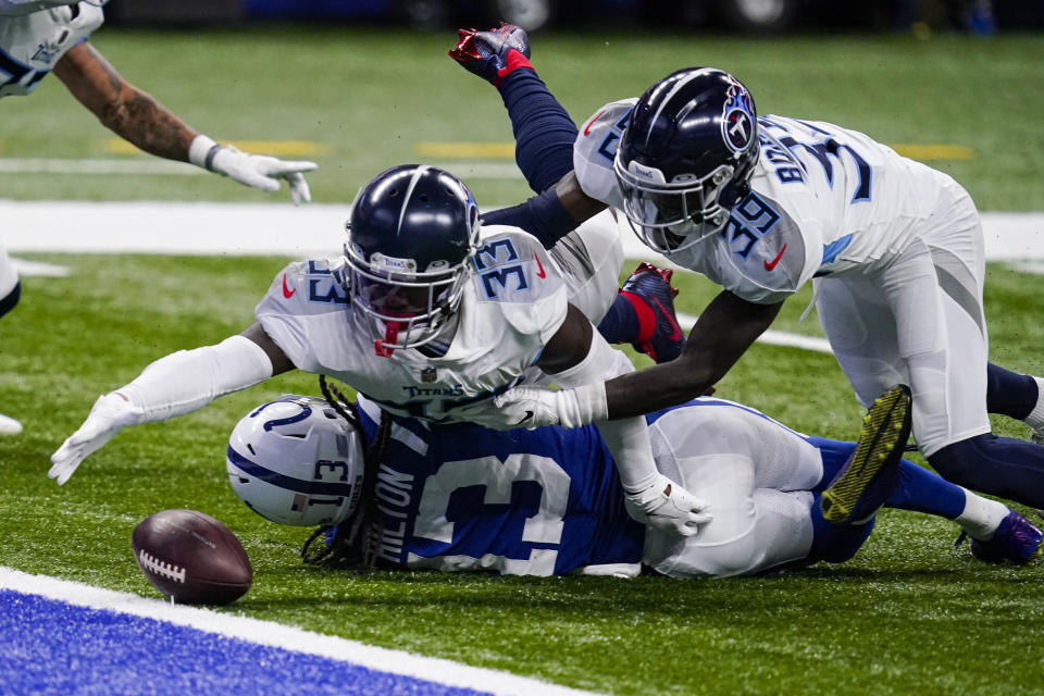 Tennessee Titans free safety Desmond King (33) reaches for a fumble by Indianapolis Colts wide receiver T.Y. Hilton (13) in the second half of an NFL football game in Indianapolis, Sunday, Nov. 29, 2020. Hilton was ruled down on the play. (AP Photo/Darron Cummings)