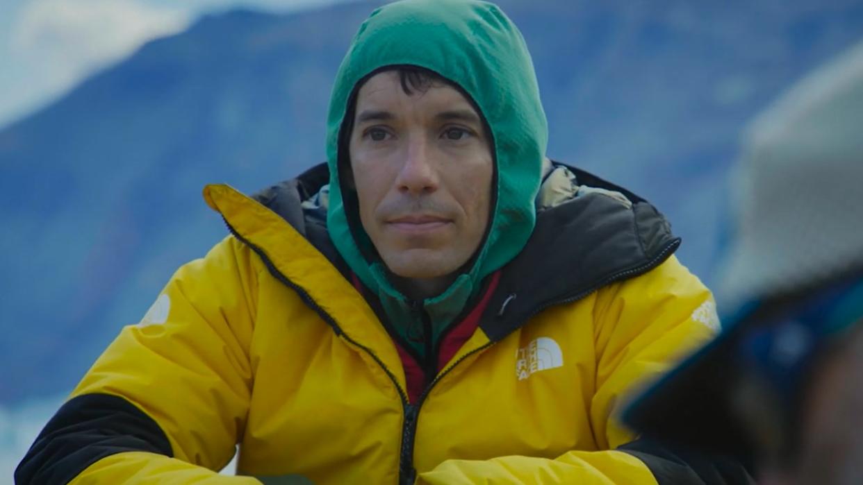  Alex Honnold sitting with a hood on in Arctic Ascent. . 
