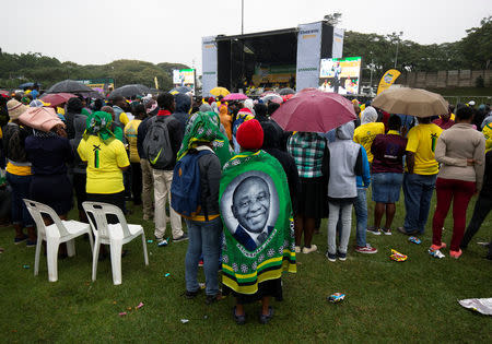 Supporters listen to South African President Cyril Ramaphosa during an African National Congress (ANC) election rally in Tongaat, near Durban, South Africa, May 4, 2019. REUTERS/Rogan Ward